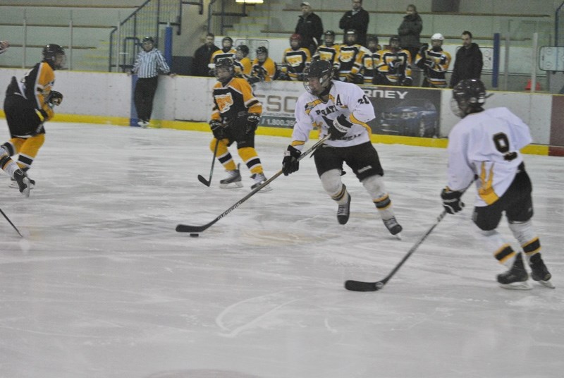 Mitchel Carstairs skates the puck out of the Pirates zone.
