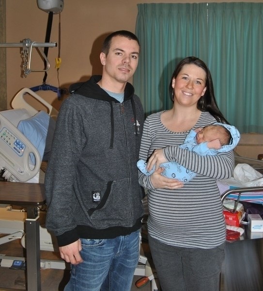 Parents Jodi Arseneault (r) and D.J. Keough pose with the newest addition to their family, Keegan James.