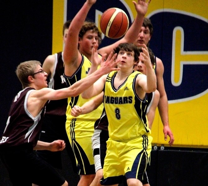 Wyatt Degner reaches for the ball as a Neerlandia player attempts to make a snag during their playoff game on Thursday, Feb. 26.