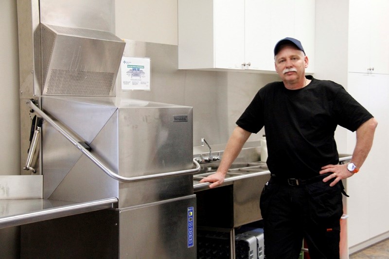 Gary Marzian, owner of G2 Commercial Repair Service Ltd. stands with the recently installed dishwasher. This piece of equipment is produced by Wexiödisk, and is considered