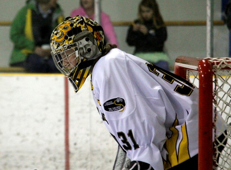 Ty Steinbring prepares for a game as they bring their season to a close. He wears his mask with pride, along with his father &#8216;s motto that &#8216;s stitched on his