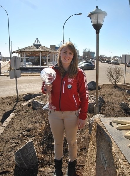 Melissa Lotholz, back in Barrhead, in her team jacket stands with her 2nd place Bobsleigh World Cup trophy.
