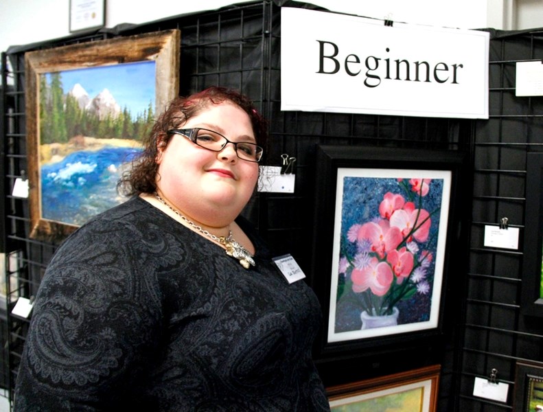 Liz Kletzel, artist, stands beside her piece, which will move on to the next stage of judging for the Alberta Wide Show in Edmonton.