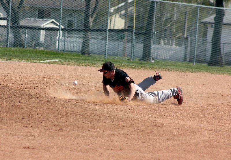 Third baseman Joel Johnson dives and just misses a shallow line drive.