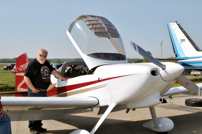 Barrhead County Coun. Bill Lane talks to the pilot of one of the planes on display.