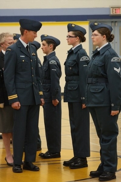 Reviewing Officer Capt. Pete Musters (l), from 408 Squadron in Edmonton, inspects the cadets who are standing at attention. Pictured are LAC Calvin Plamondon, LAC Mary Ann