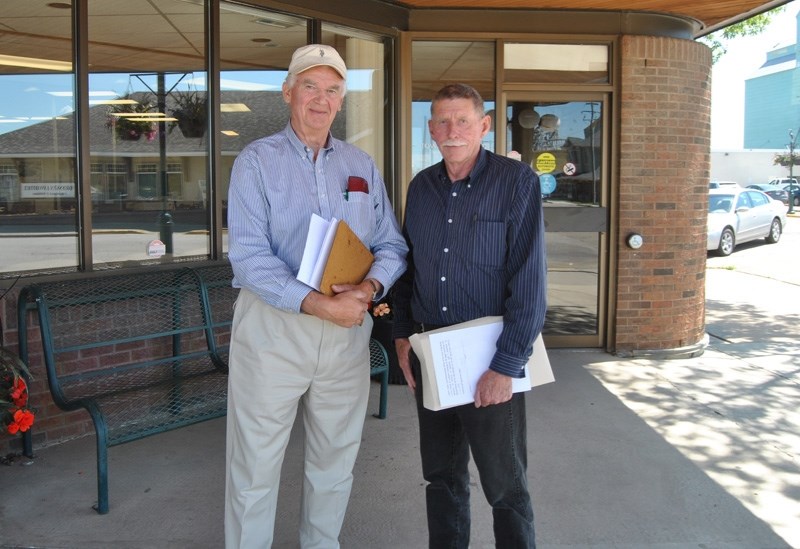 Manfred John (l), a Town of Barrhead resident for more than 50 years, joins Chuck Hambling at the Town of Barrhead municipal office to submit a petition on Wednesday, June