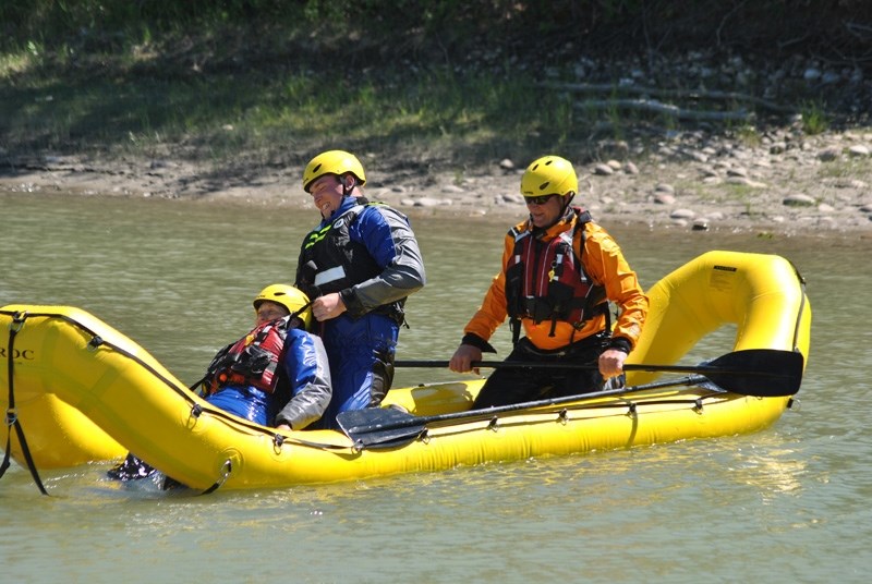 From left: Doris Kuelken, Avery Degroot and Peter Kuelken of the Fort Assiniboine Fire Department take part in a swift water rescue course put on by Raven Rescue on Sunday,