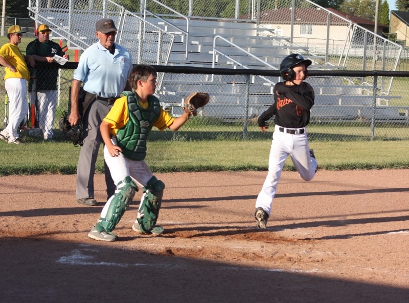 Keaton Brandon crosses home plate.