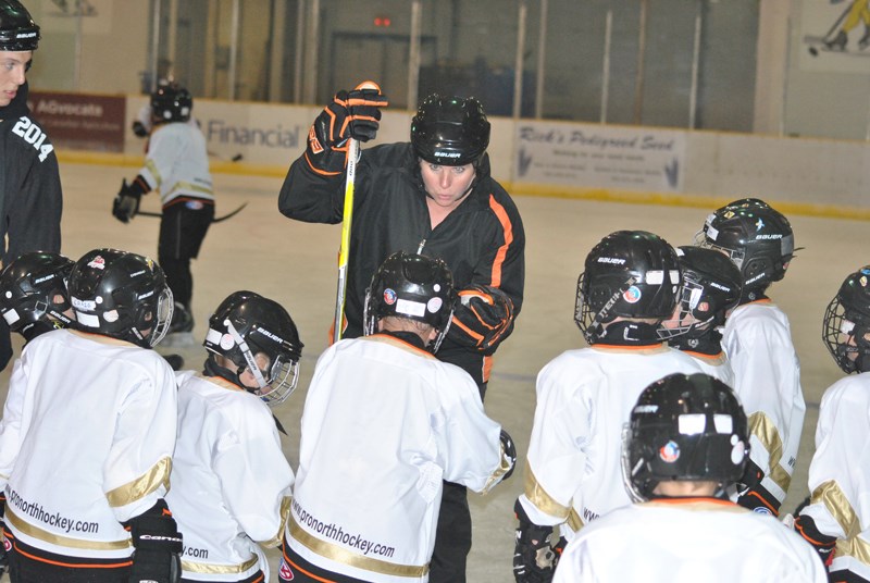 Chris Driessen, founder of the Pro North Hockey Camp, gives a group of players some instruction on a skating drill.