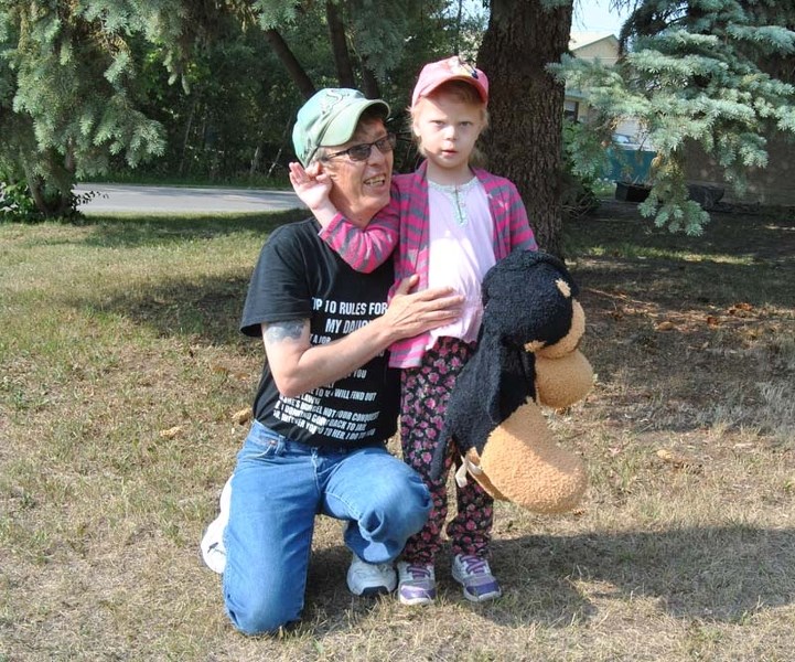 Carson Meunier and his daughter Blaze take a break from playing in the yard to talk to the Leader about a concern over bussing.