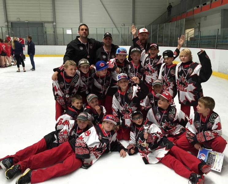 Jason Kelly celebrates with his teammates after the Cowboys captured the silver medal in the Czech Challenge Cup. Jason is the one with his hands up.