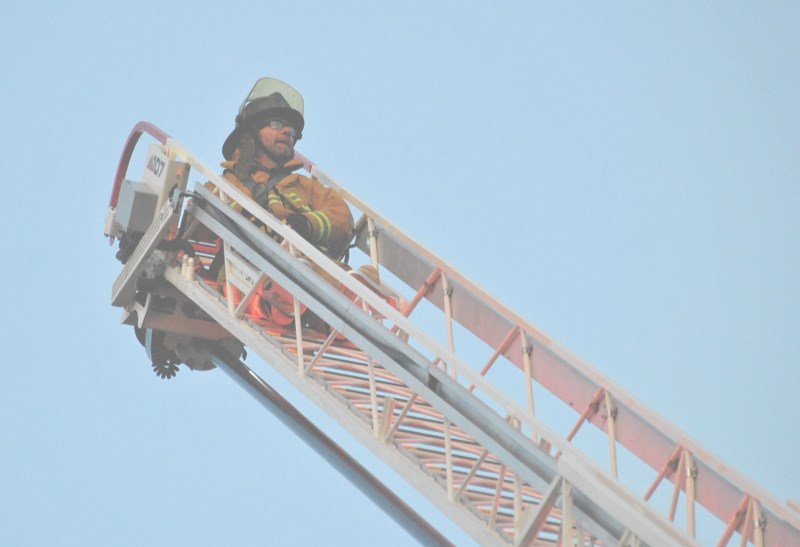 Town Coun. Don Smith takes in the view on from the top of 107-foot ladder truck.