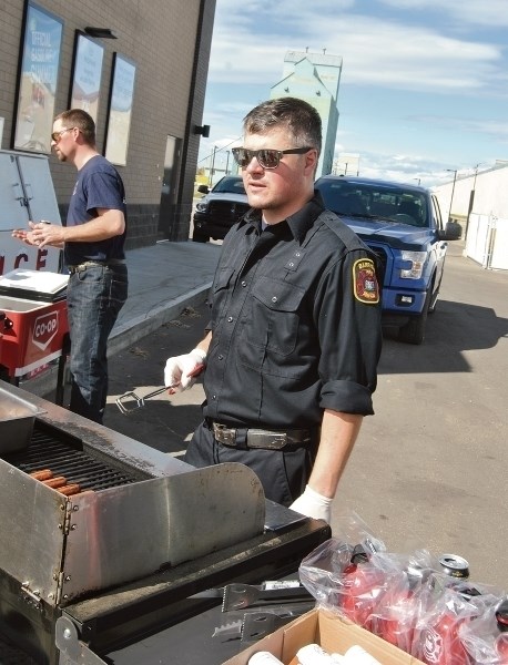 Barrhead firefighter Dave Friesen mans the barbeque during a recruitment/information session at the Pembina West Co-op Gas Bar on Saturday, Sept. 12.