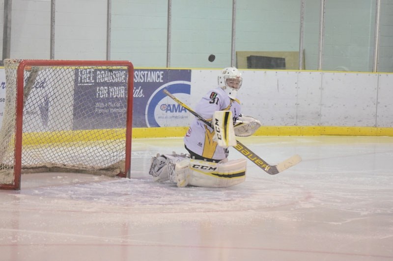 Goaltender Logan Branden tracks where the puck is going after it hit him in the chest.