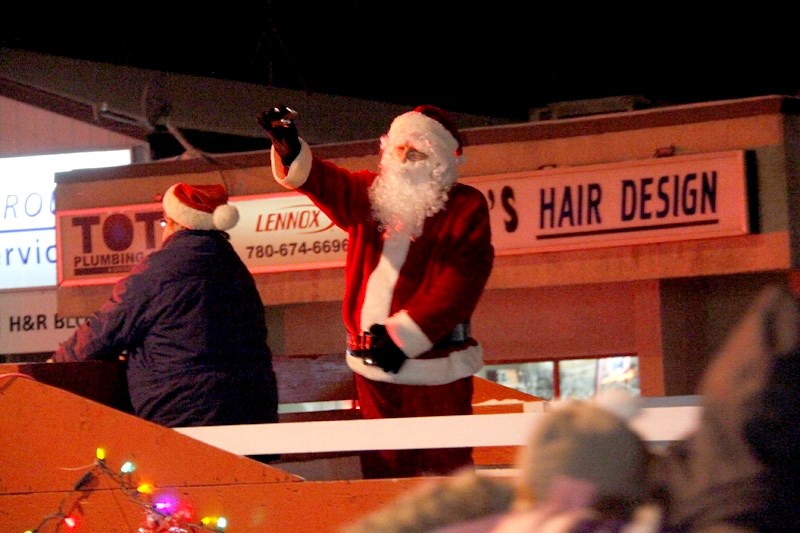 Santa waves at children and their families as he makes his way down Main Street during last year &#8216;s Light Up Night.