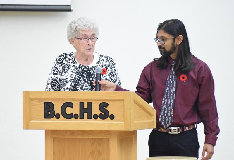 Prakash Raju, BCHS associate principal, holds the microphone for Henny Mast. Mast was the keynote speaker during the school &#8216;s Remembrance Day ceremony.