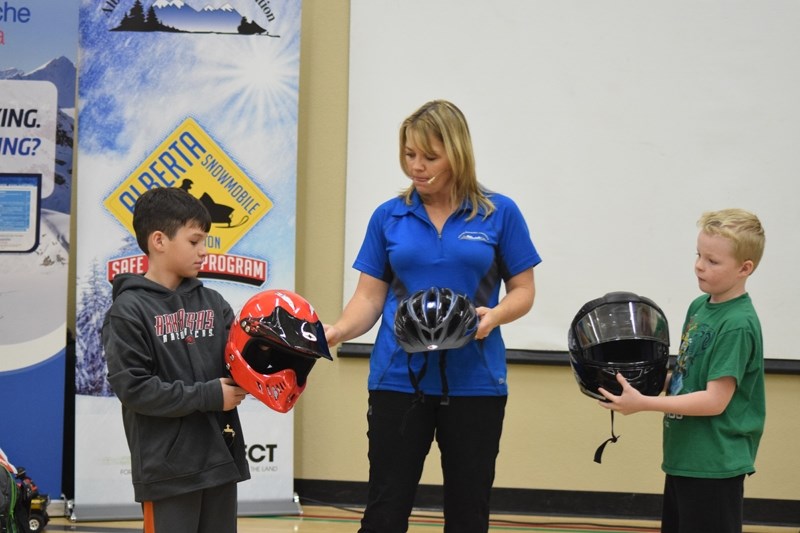 Rowdy Christianson (l), Lori Zacaruk, from the ASA and Mason Golden. One of these helmets are not proper OHV rider wear. Zacaruk asks the students why.