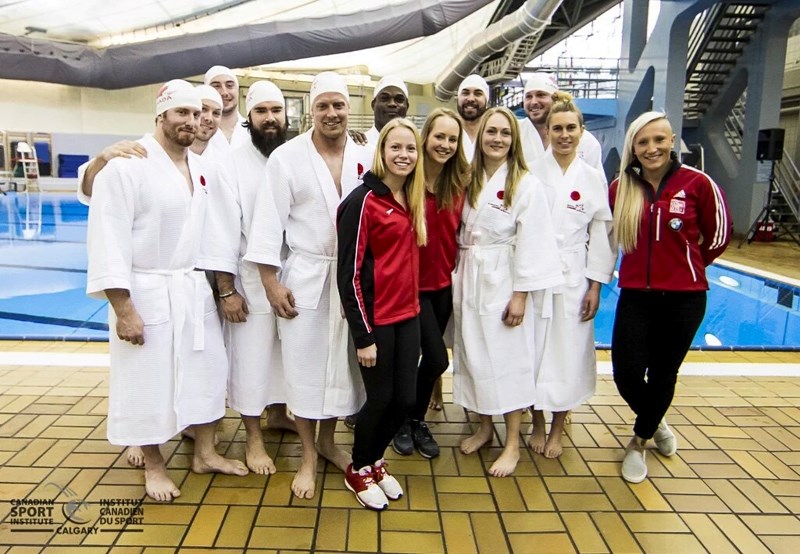 The members of the Canadian national bobsleigh team pose with synchronized swimming duo Karine Thomas and Jacqueline Simoneau.