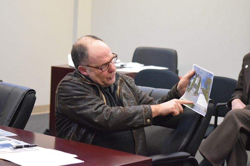 Rick Hofsink points to where the parking spots would be in a development he is planning to build at the old Canadian Reformed Church site.