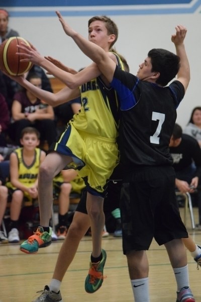 Rylan Sonnenberg leaves his feet for a layup in a game against Athabasca.