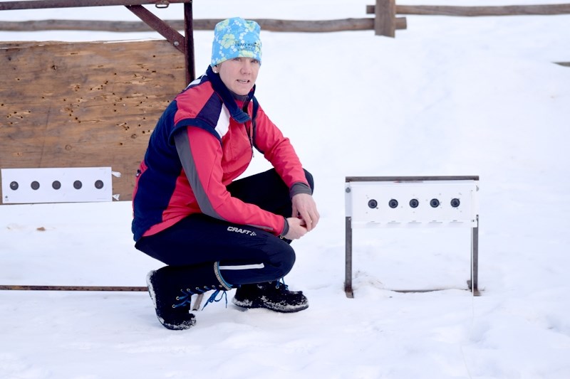 Ntala Quintilio shows the type of electronic target her son, Henrik will have to shoot at the Alberta Winter Games. Henrik is aiming at the small centre portion of the black