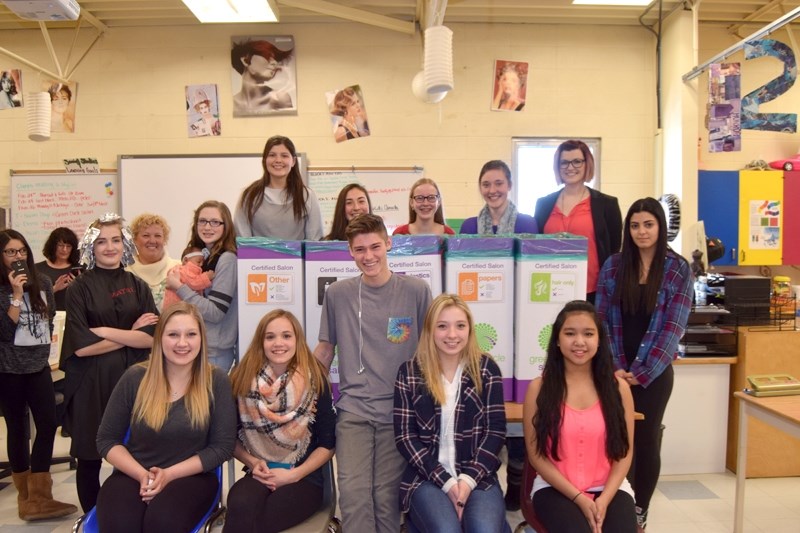 Jennifer Teefy &#8216;s (back row, right) introduction to cosmetology class stands with BCHS &#8216;s new salon waste sorting system. This new system will enable BCHS