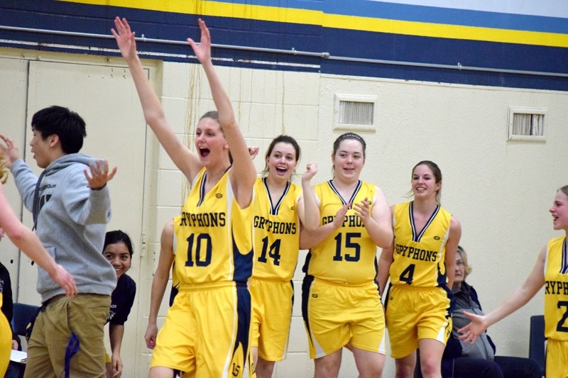 The Barrhead Lady Gryphons bench erupts after Taylor Schmidt hits a buzzer beating shot from beyond centre court just before half time in the bronze medal game.