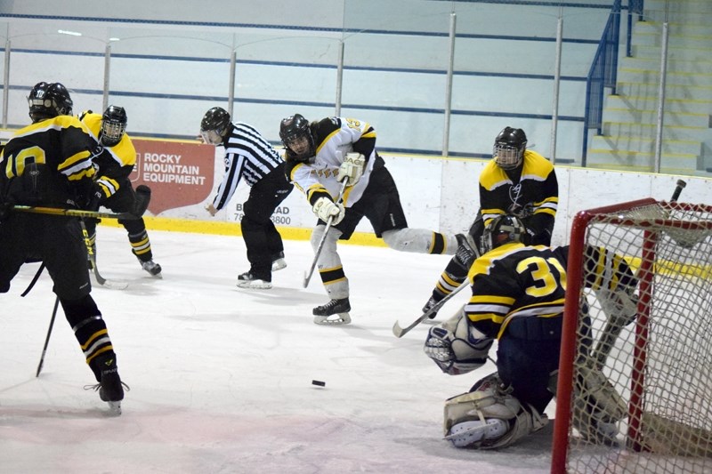 Koby Adams tries to squeak a shot past the Athabasca goaltender by aiming for the far post. Although Adams didn &#8216;t score on the play he did end the night with three