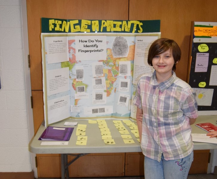 Amber V. stands beside her Barrhead Elementary School Science Fair project.