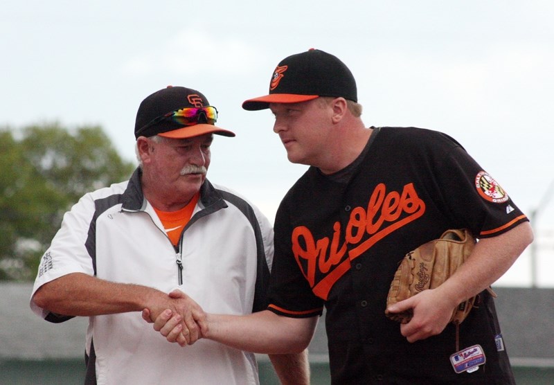 Former Barrhead Blue Jay and North Central Alberta Baseball League Barrhead Oriole alumni, John Osbourne (L) shakes hands with 2016 Orioles player Craig Connolly after being