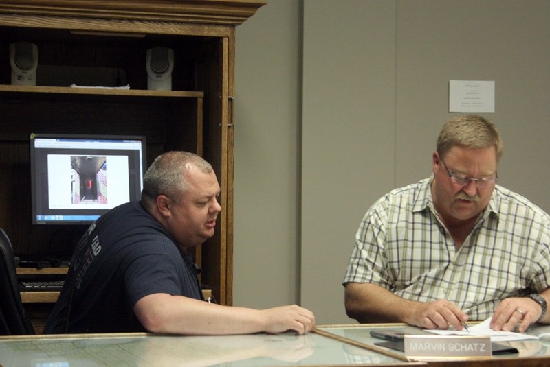 Barrhead Fire Chief John Whittaker discusses the finer points of the platform truck his department wukk siib ve acquiring, thanks to an agreement between the Town of Barrhead 