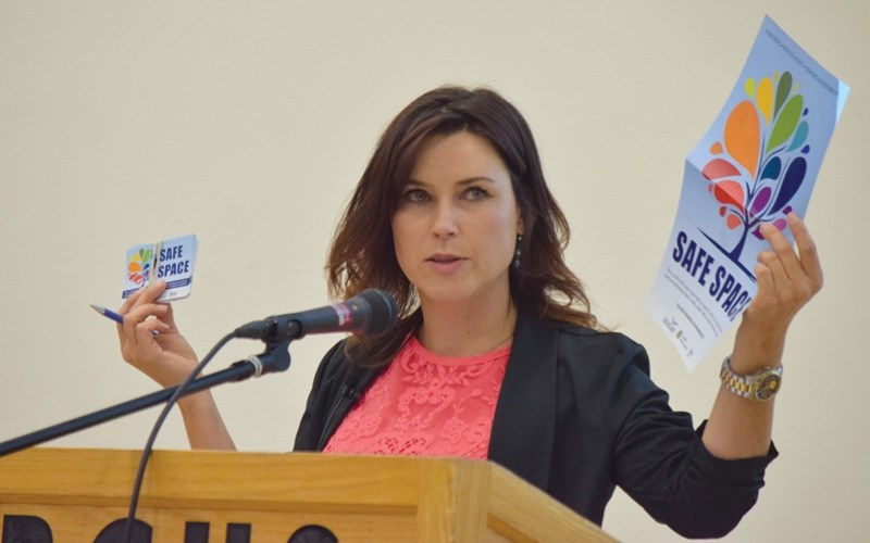 Andrea Berg, executive staff officer for the ATA, shows PHPS staff some of the materials for schools that can be put up to help LGBTQ students feel safe and welcome.