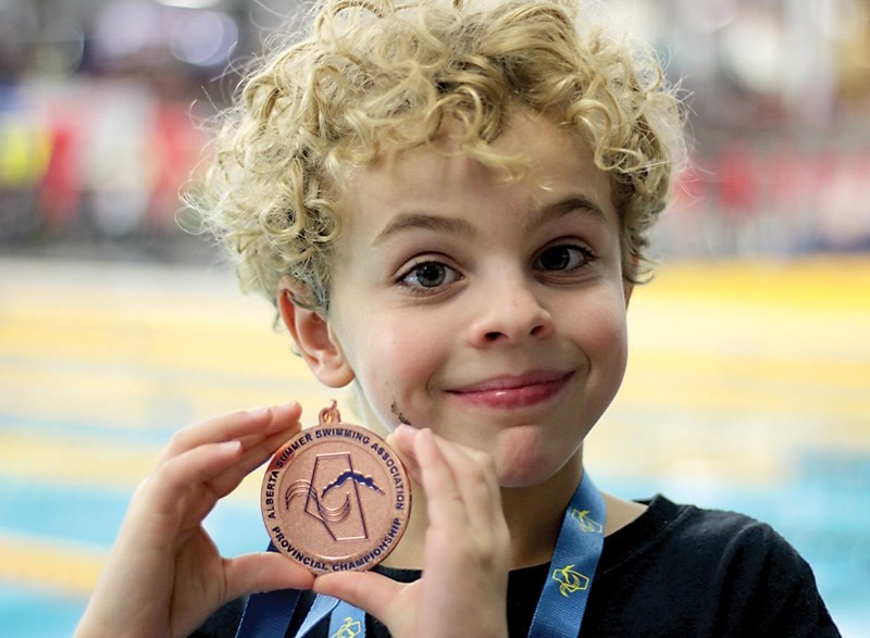 Kyler Tuininga shows off his bronze medalhe won at the ASSA Provincial Championships.