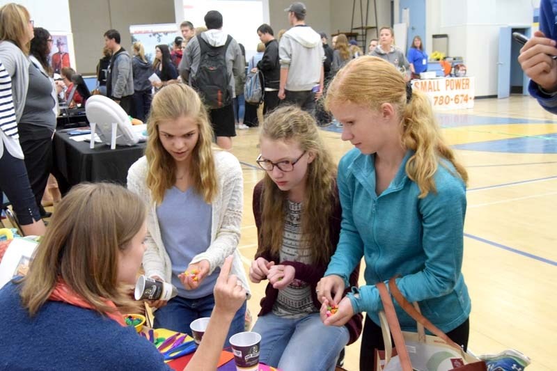From left: Neerlandia Public Christian School Grade 9 students Hannah Tuininga, Sophia Demuynck and Laura Olthuis take part in a fine motor control exercise designed for