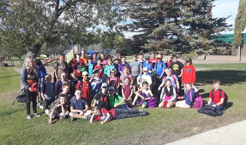 The BES cross-country team takes a final picture together after returning from their first and final meet of the year.
