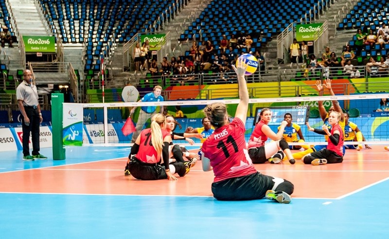 Heidi Peters, number 11, makes a one handed smash from the back row in Canada &#8216;s final game against Rwanda in the 2016 Rio Paralympic Games.