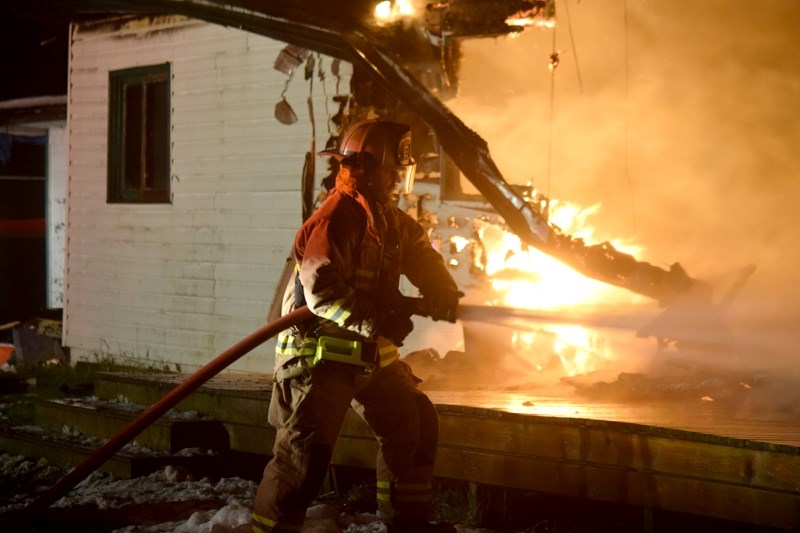 A member of the Westlock firefighter helps out the Barrhead Fire Department during a structure fire on Range Road 53.