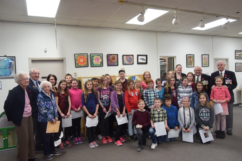 Students and veterans pose for a group picture after the Veterans &#8216; Tea.