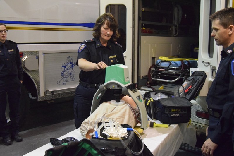 Fort Assiniboine firefighter Doris Kuelken demonstrates how the LUCAS CPR system works during an open house for Woodlands County councillors in February.