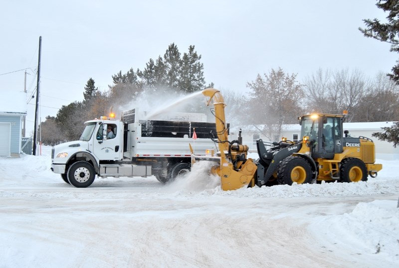 Town of Barrhead work crews are poised to keep the streets clear of snow. Here we can see an example of their work as they clear snow use a snow removal machine-dump truck