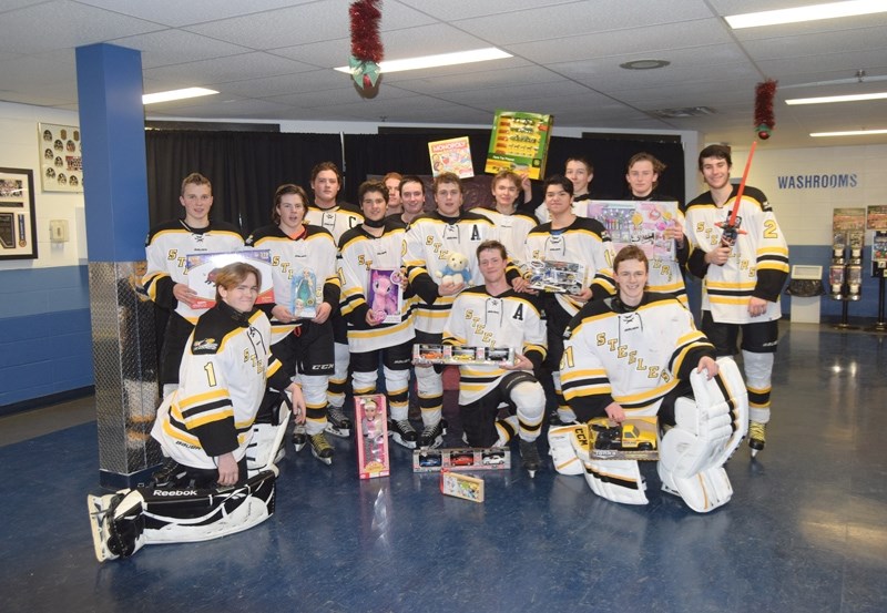The Barrhead Steelers pose after the game with just a few of the toys fans donated during the team &#8216;s annual Santa &#8216;s Toy Box drive at the Agrena on Friday, Dec.