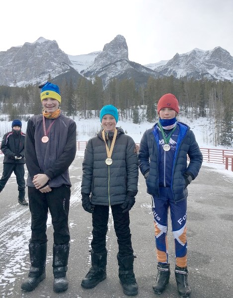 Henrik Quintilio (m) with Lance Sekora (l) of Devon Bears, who trains with Quintilios and Aidan Latime of Foothills Nordic after a race in Camrose on Jan. 8.