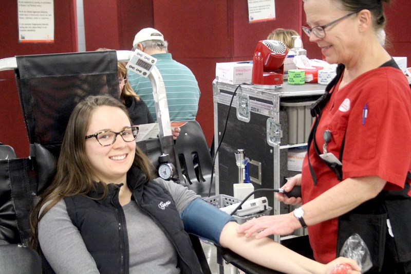 Deanna Exley (l) makes herself comfortable while CBS volunteer Coralee Farrel gets everything ready to accept the donation.