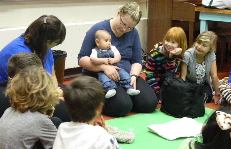 Roots instructor Tamara Hubscher with mom Nikki Cabral and her son Ian during a session at BES in 2016. Student Adriana Parker (red head) and Kaylan Hiemstra (blonde)