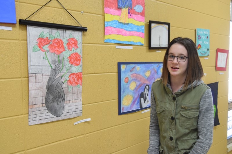 Ashlyn Hladilo talks about her favourite piece in the artshow titled &#8216;Lighten Up. &#8221; She said the reason why she decided against using colour for the heart was so