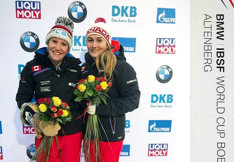 Kailie Humpries (r) and Melissa Lotholz hold a ceremonial bouquet of flowers in addition to their gold medals after winning a World Cup event in Altenberg, Germany.