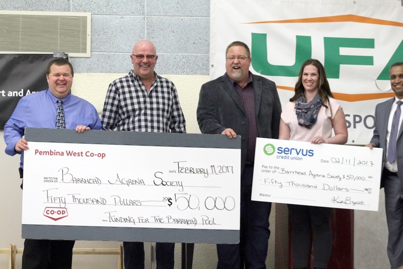 Pembina West Co-op (represented by Allan Cote, far left, and Marvin Schatz, middle,) and Servus Credit Union (represented by Kristine Bryant, second from right and James