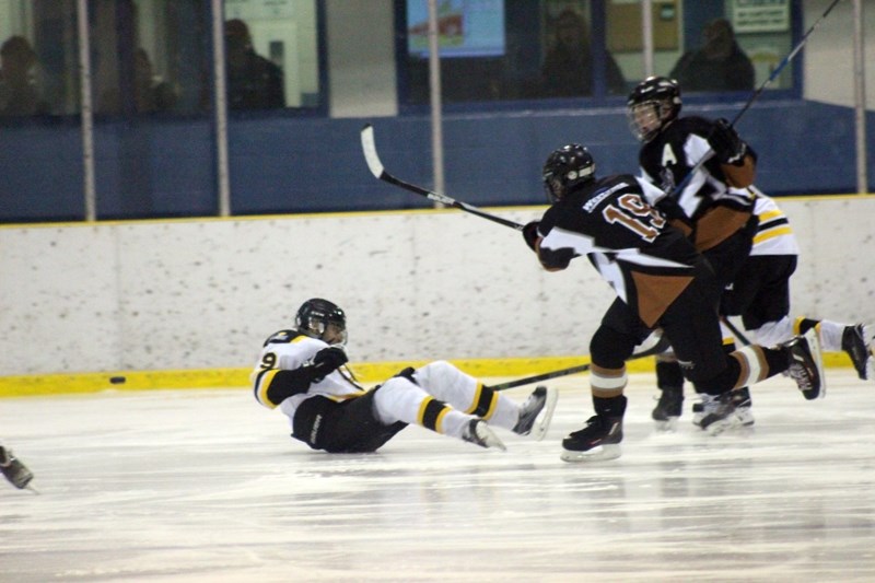 Barrhead Pirates player Siraj Assaf slides across the ice after taking a hit from a Warburg Thunder player during the second game of league playoffs in Barrhead on March 2.