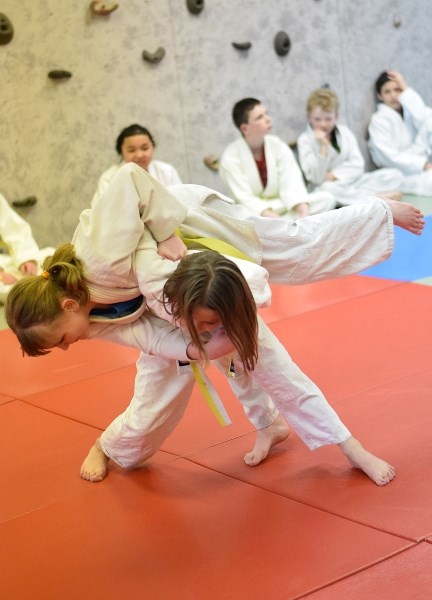 Alayna Bohnet uses a hip technique to throw Jessica Jenkins.